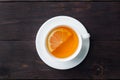 White Cup with natural herbal tea with lemon cinnamon. Hot vitamin drink is used for colds.Dark wooden background copy space Royalty Free Stock Photo