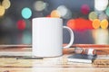 White cup with pen, diary and eyeglasses on wooden table Royalty Free Stock Photo