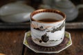 White cup on a plate. Ceramic glazed cup for a traditional tea ceremony.