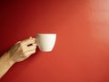 A white cup on a red background