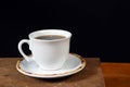 White cup with roasted coffee beans isolated with copy space