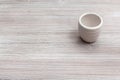 White cup for sake on gray brown wooden board