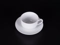 White cup on a saucer isolated on black background Royalty Free Stock Photo