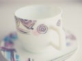 White cup and saucer on the table. Crockery for tea with a modern geometric pattern