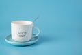 White Cup on saucer with teaspoon