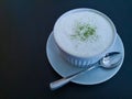 A white cup of soft drink is MATCHA Green tea late on wooden table Royalty Free Stock Photo