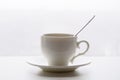 White cup with spoon and saucer on white background Royalty Free Stock Photo