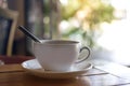 White cup of steaming hot coffee on the wooden table Royalty Free Stock Photo