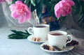 White cup of tea on a background of a vase