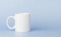 white cup for tea or coffee on a blue background Royalty Free Stock Photo