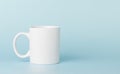 white cup for tea or coffee on a blue background Royalty Free Stock Photo