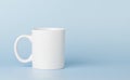 white cup for tea or coffee on a blue background Royalty Free Stock Photo