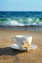 White cup with tea or coffee on sand beach front of sea Royalty Free Stock Photo