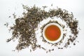 White cup of tea with dried tea leaf on the white background Royalty Free Stock Photo