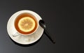 White cup tea with lemon on dark background Royalty Free Stock Photo