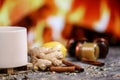 White cup of tea with lemon, ginger, orange, jam and medical mask against the background of a burning fireplace.Healthcare.