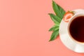 White cup of tea with mint leaves and red ripe strawberries on pink background. summer vitamin tea. top view Royalty Free Stock Photo