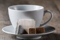 White Cup for tea, tea bag and pieces of sugar. Royalty Free Stock Photo