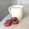 White Cup of tea and purple macaroons. Close up