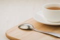 white cup of tea and spoon on a wooden tray/white cup of tea and spoon on a wooden tray on a wooden background. Copy space Royalty Free Stock Photo