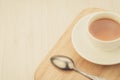 White cup of tea and spoon on a wooden tray/white cup of tea and spoon on a wooden tray. Top view. Copy space Royalty Free Stock Photo