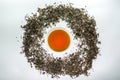 White cup of tea surrounded by dried tea leaf Royalty Free Stock Photo