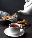 White cup of tea and teapot pour cookies handmade close up Royalty Free Stock Photo