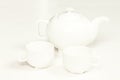 White cup and teapot fot tea or coffee Royalty Free Stock Photo