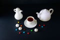 White cup, teapot and milk jug on a black background Royalty Free Stock Photo