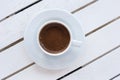 White cup of Turkish coffee on saucer on light wooden table. Top view with copy space. Lifestyle background Royalty Free Stock Photo