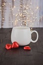 White cup with Valentine chocolate candy red hearts Royalty Free Stock Photo