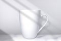 White cup on white studio background. Empty cup mockup. Side view. Blank ceramic mug with shadow. 3d cup front with soft light for Royalty Free Stock Photo