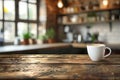 White cup on wooden table on blurred kitchen background Royalty Free Stock Photo