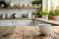 White cup on wooden table on blurred kitchen background Royalty Free Stock Photo