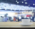 White cup on wooden table over defocused light and shadow of sho Royalty Free Stock Photo