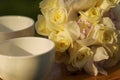 White cups and bridal bouquet