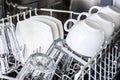 White cups in new dishwasher Royalty Free Stock Photo