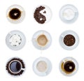 White cups and saucers with coffee, tea, coffee beans and sugar. Set of cups on a white background, isolated. Splashes, top view Royalty Free Stock Photo