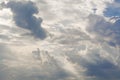 White curly clouds in a blue sky with dark clouds. Sky background. Royalty Free Stock Photo