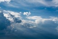 White curly clouds in a blue sky with dark clouds. Sky background. Royalty Free Stock Photo