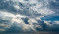 White curly clouds in a blue sky with dark clouds. Sky background. Royalty Free Stock Photo