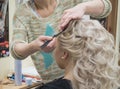 White curly curls hairstyle in the hair salon.