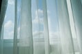 White curtain on window, blue sky background Royalty Free Stock Photo