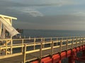 White curtains in the wind against the sea and red bridge