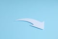 White curved paper arrow on light blue background