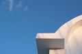 White curved roof of building against blue sky. Minimal Architecture symmetry