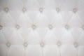 White cushioned background with buttons