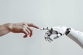 A white cyborg robotic hand with an extended finger pointing toward a human hand with an extended finger. AI robot finger and