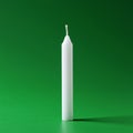 A white, cylindrical candle with a pointed tip and a visible wick stands vertically again Royalty Free Stock Photo