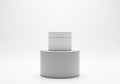 White cylindrical container with a smooth surface, placed on a Royalty Free Stock Photo